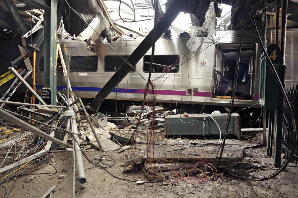 FILE – This Oct. 1, 2016, file photo provided by the National Transportation Safety Board shows damage from a Sept. 29, 2016, commuter train crash that killed a woman and injured more than 100 people at the Hoboken Terminal in Hoboken, N.J. NJ Transit has reached settlements in lawsuits filed by the family of a woman killed and people injured in a 2016 crash when a train slammed into the Hoboken station. NJ Transit spokesperson Nancy Snyder said settlements were reached in the lawsuits on Wednesday evening, May 12, 2021, NJ.com reported. (Chris O'Neil/National Transportation Safety Board via AP, File)