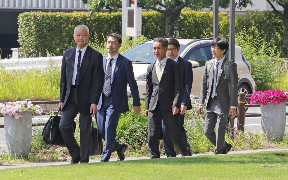 Officials from the Ministry of Land, Infrastructure, Transport and Tourism enter Toyota's headquarters for an inspection