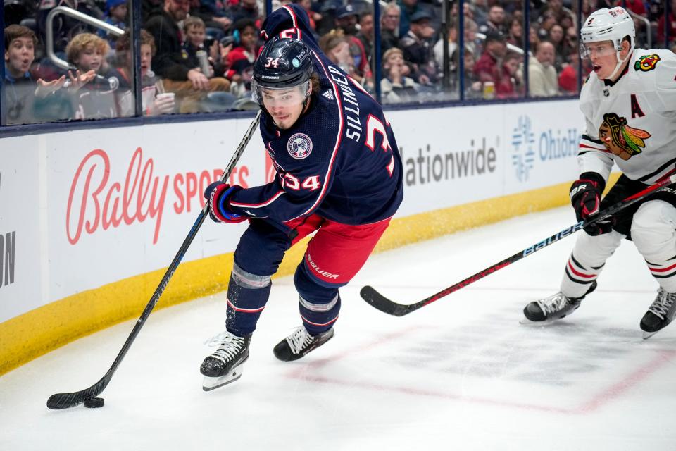 Dec 31, 2022; Columbus, Ohio, USA;  Columbus Blue Jackets center Cole Sillinger (34) is defended by Chicago Blackhawks defenseman Connor Murphy (5) during the first period of the NHL hockey game between the Columbus Blue Jackets and the Chicago Blackhawks at Nationwide Arena on Saturday afternoon.