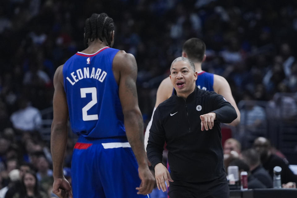 Los Angeles Clippers head coach Tyronn Lue, right, speaks with forward Kawhi Leonard (2) during the first half of an NBA basketball game against the Minnesota Timberwolves, Monday, Feb. 12, 2024, in Los Angeles. (AP Photo/Ryan Sun)