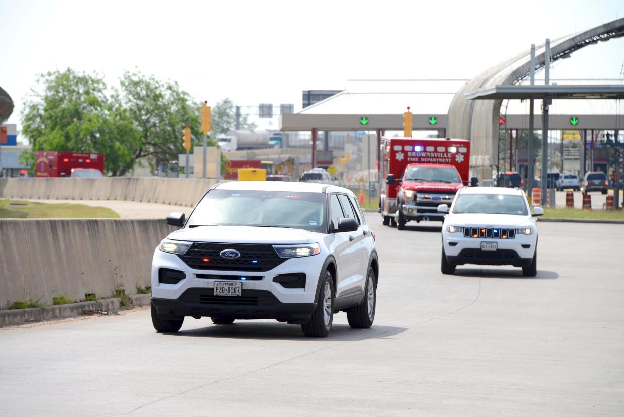 Two FBI vehicles escort two Brownsville Fire Department EMS Ambulances through Veterans International Bridge at Los Toma (AP)