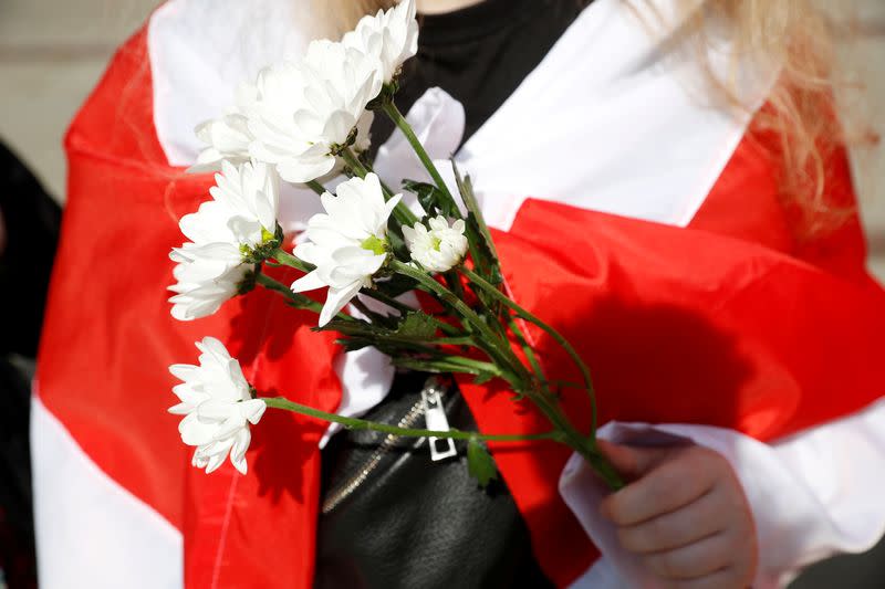 FILE PHOTO: People carrying historical white-red-white flags of Belarus gather in Warsaw