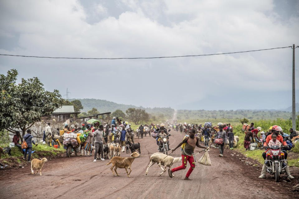 People walk on the road near Kibumba, north of Goma, Democratic Republic of Congo, as they flee fighting between Congolese forces and M23 rebels in North Kivu, Tuesday, May 24, 2022. Elections, coups, disease outbreaks and extreme weather are some of the main events that occurred across Africa in 2022. Experts say the climate crisis is hitting Africa “first and hardest.” Kevin Mugenya, a senior food security advisor for Mercy Corps said the continent of 54 countries and 1.3 billion people is facing “a catastrophic global food crisis” that “will worsen if actors do not act quickly.” (AP Photo/Moses Sawasawa)