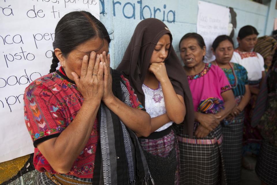 Women mourn during the burials of Carlos Daniel Xiquin, 10, and Oscar Armando Toc Cotzajay, 11, who were kidnapped over the weekend and then killed when family could not raise the ransom money, in Ajuix, Guatemala, Tuesday, Feb. 14, 2017. Authorities found the bodies of the two boys on Sunday, stabbed and thrown into sacks in the municipality of San Juan Sacatepéquez, northwest Guatemala. (AP Photo/Moises Castillo)