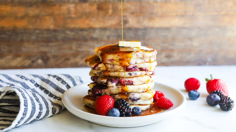 Syrup pouring on fresh pancakes