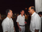 PAP's Koh Poh Koon speaks with Deputy Prime Ministers Teo Chee Hean and Tharman Shanmugaratnam backstage. (Yahoo! photo/Alvin Ho)