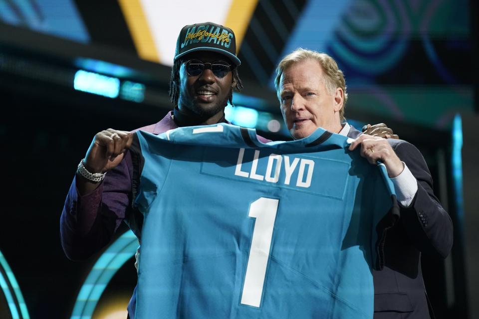 Utah linebacker Devin Lloyd stands with NFL Commissioner Roger Goodell after being chosen by the Jacksonville Jaguars with the 27th pick of the NFL football draft Thursday, April 28, 2022, in Las Vegas. (AP Photo/John Locher)