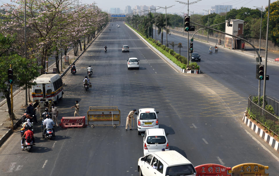 MUMBAI, INDIA - MARCH 24: Mumbai Police checking ID card during restrictions on citizens movement at Eastern Express Highway, Ghatkopar due to COVID-19 pandemic, on March 24, 2020 in Mumbai, India. (Photo by Satish Bate/Hindustan Times via Getty Images)