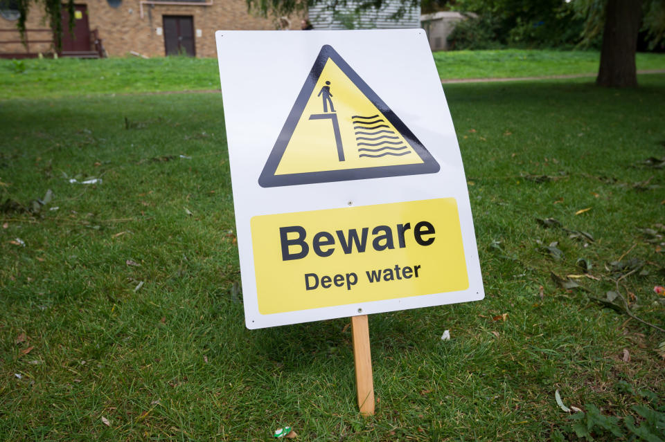 Signs warning of deep water that have been put at the spot where two year old Ruby was pulled out of the river Nene (SWNS)