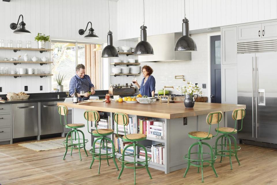 large modern farmhouse kitchen with green stools around the large island