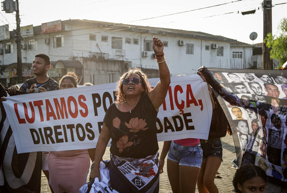 Relatives, activists and residents protest against a police raid that killed more than a dozen of people in Guaruja, Sao Paulo state, Brazil, Wednesday, Aug. 2, 2023. The death toll from the raid has climbed to at least 14, in a sprawling operation that has raised questions about the use of lethal force by police. (AP Photo/Tuane Fernandes)