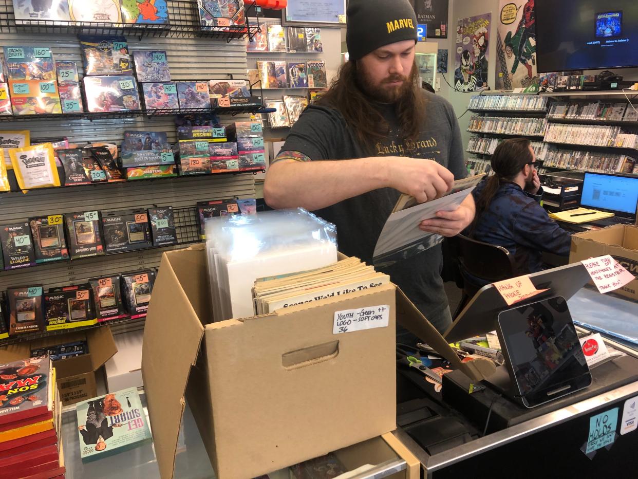 Zach Hauser, owner of The Turning Page, prepares for Free Comic Book Day, which is Saturday.