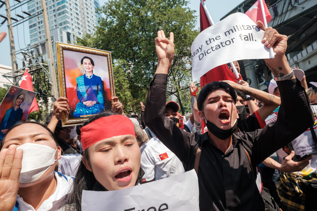 Protesters are shouting slogans while holding pro-democracy signs and pictures of deposed leader Aung San Suu Kyi as the crowd gathers in front of the Myanmar Embassy in Bangkok, Thailand, on February 1, 2023. (Thomas De Cian/NurPhoto via Getty Images)