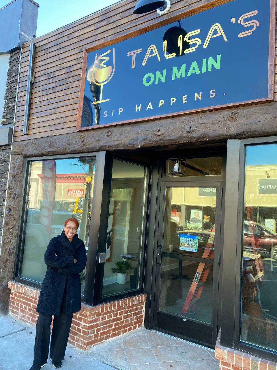 Owner Talisa Proctor stands in front of her soon-to-open wine bar, Talisa's on Main, at 65 Main St. in Taunton, on Wednesday, Dec. 20, 2023.
