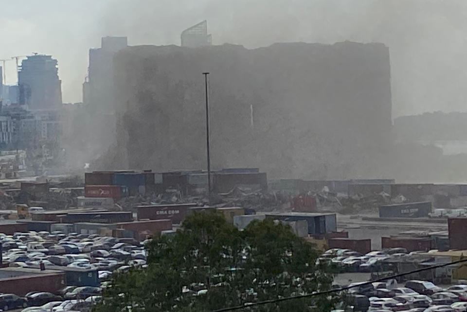 Dust covers the silos damaged during the August 2020 massive explosion in the port, after part of it collapsed, in Beirut, Lebanon, Sunday, July 31, 2022. A section of Beirut's massive port grain silos, shredded in the 2020 explosion, collapsed on Sunday after a weekslong fire triggered by grains that had fermented and ignited in the summer heat. (AP Photo/Mohammed Anouti)