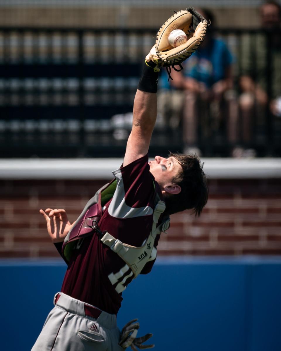 Oriskany's David Cronauer catches a foul ball during the finals of the Section III Class D baseball tournament at Onondaga Community College.