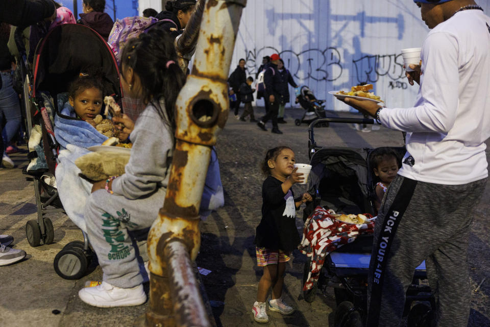 Migrants eat outside a shelter in Chicago