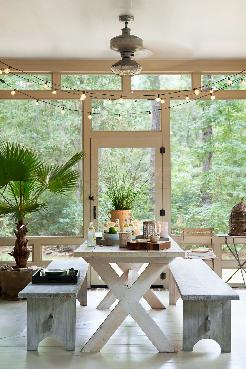 screened porch with picnic table and benches