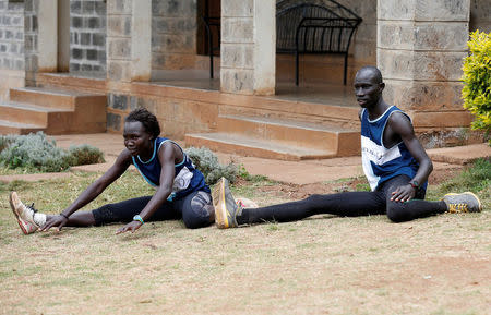 Rose Nathike Lokonyen and James Nyang Chiengjiek, refugees from South Sudan, part of the refugee athletes who qualified for the 2016 Rio Olympics, stretch during a training session at their camp in Ngong township near Kenya's capital Nairobi, June 9, 2016. REUTERS/Thomas Mukoya/Files