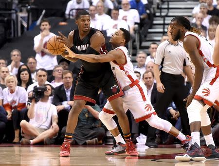 Miami Heat forward Joe Johnson (2) holds the ball away from Toronto Raptors guard Kyle Lowry (7) in game two of the second round of the NBA Playoffs at Air Canada Centre. The Raptors won 96-92. Mandatory Credit: Dan Hamilton-USA TODAY Sports