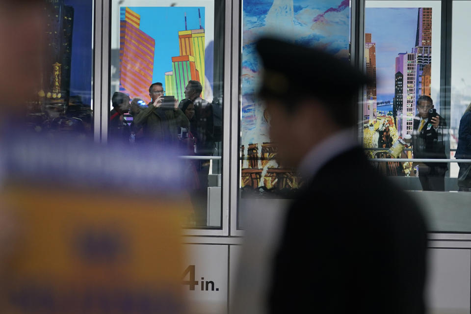 Airline passengers photograph member of the Air Line Pilots Association International during an informational picket on behalf of United Airline pilots at O'Hare International Airport Friday, May 12, 2023, in Chicago. (AP Photo/Charles Rex Arbogast)