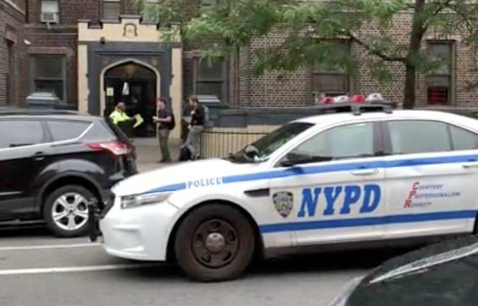 A police car sits outside the woman, who is now in hospital, who threw her kids out of the window. (Peter Gerber)