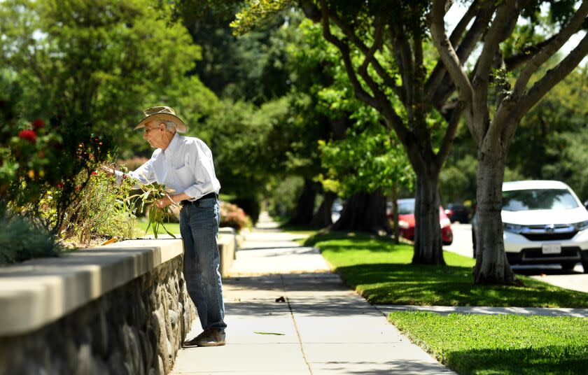 Pasadena, California April 15 2022- A resident pulls weeds near a house that sold for $2.5 million in cash after being listed for 1.2 million on Stratford Ave. in South Pasadena. (Wally Skalij/Los Angeles Times)