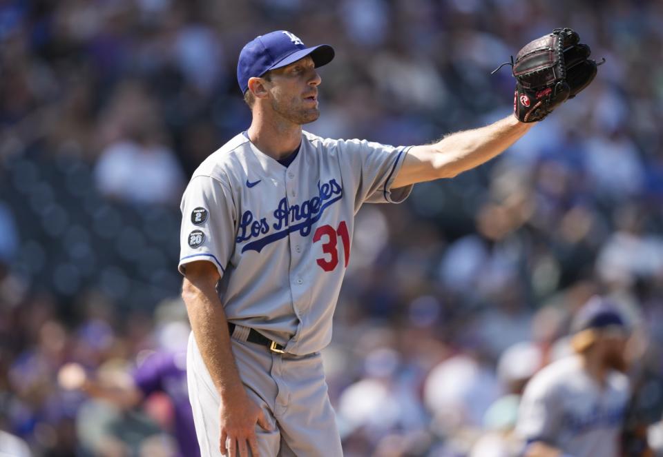 Dodgers starting pitcher Max Scherzer calls for the ball after giving up a run-scoring single.