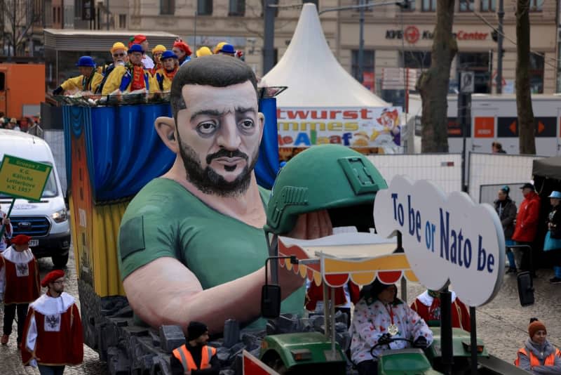 A motif float of President of Ukraine Volodymyr Zelensky, To be or Nato be, rides in the Rose Monday parade. The Rhineland Street Carnival reaches its climax with the Rose Monday parade. The motto of the 2024 Cologne Carnival season is "Wat e Theater - wat e Jeckespill". Oliver Berg/dpa