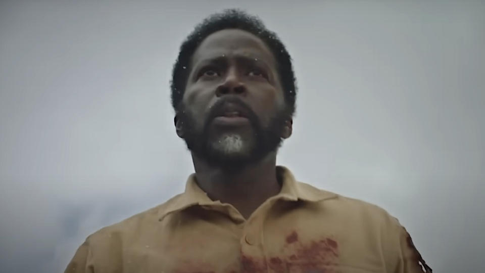 Harold Perrineau's Boyd wearing a bloody yellow shirt and looking off into the distance in From Season 3