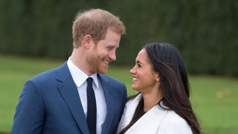 LONDON, ENGLAND - NOVEMBER 27: Prince Harry and Meghan Markle, wearing a white belted coat by Canadian brand Line The Label, attend a photocall in the Sunken Gardens at Kensington Palace following the announcement of their engagement on November 27, 2017 in London,  England. (Photo by Anwar Hussein/Getty Images)