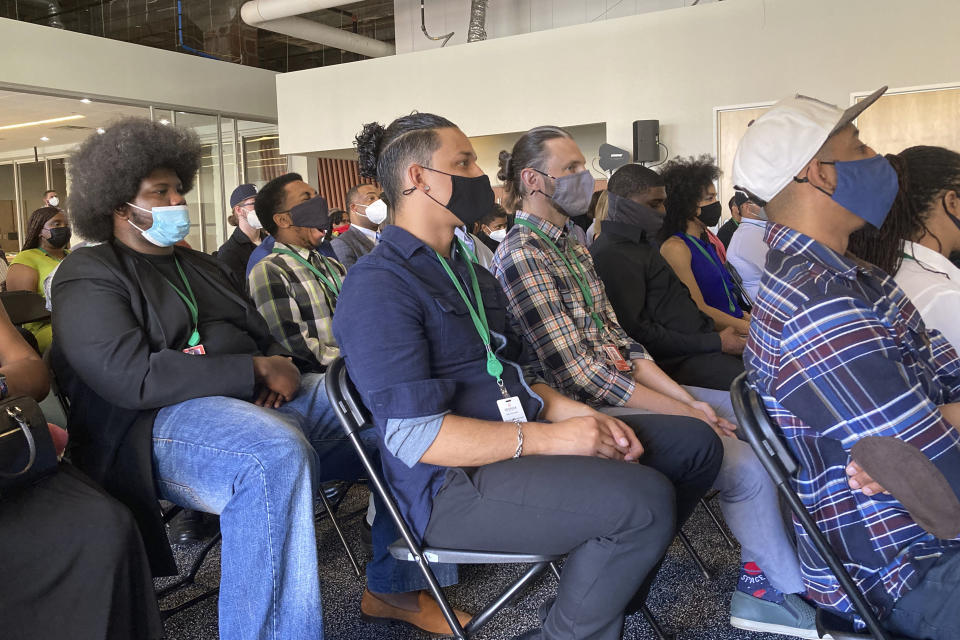 Graduates from the first cohort of the Detroit Apple Developer Academy listen to a speaker during a ceremony held Thursday, June 30, 2022, in Detroit. The inaugural class of the Detroit Apple Developer Academy, a free program that teaches students the fundamentals of coding, design, marketing and project management, celebrated its unique accomplishment during a ceremony held Thursday. (AP Photo/Mike Householder)