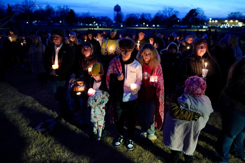 Local residents pray during a candlelight vigil following a shooting at Perry High School, Thursday, Jan. 4, 2024, in Perry, Iowa.
