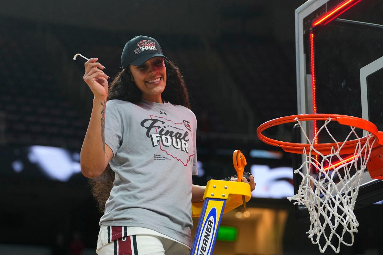 South Carolina center Kamilla Cardoso (10) cuts down the net to celebrate the victory after the Gamecocks reached the Final Four.