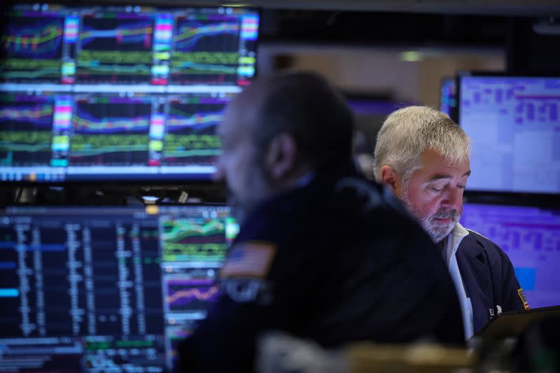 Traders work on the floor of the NYSE in New York