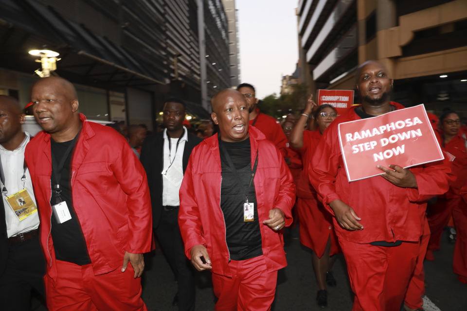 Julius Malema, center, of the Economic Freedom Fighters (EFF) outside the city hall in Cape Town, South Africa, Thursday, Feb. 9, 2023 after disrupting South African President, Cyril Ramaphosa's, State of the Nation address. Ramaphosa is under pressure to convince the country that his government is addressing the nation's dire electricity crisis and bleak economic outlook in his annual State of the Nation Address. (AP Photo/Nardus Engelbrecht)