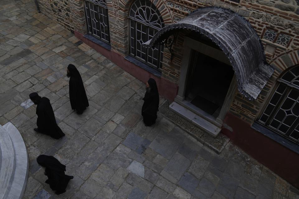 Monks exit from the church after the afternoon prayers at the Pantokrator Monastery in the Mount Athos, northern Greece, on Thursday, Oct. 13, 2022. The monastic community was first granted self-governance through a decree by Byzantine Emperor Basil II, in 883 AD. Throughout its history, women have been forbidden from entering, a ban that still stands. This rule is called "avaton" and the researchers believe that it concerns every form of disturbance that could affect Mt. Athos. (AP Photo/Thanassis Stavrakis)