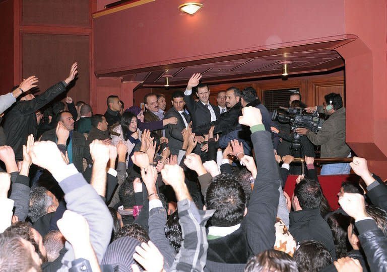 Picture released by the official Syrian Arab News Agency shows embattled President Bashar al-Assad waving to supporters at the end of his speech on the latest developments in the country and the region on January 6, 2013 at the opera house in Damascus. Assad outlined a three-phase plan to resolve the 21-month conflict in his country in which, according to the UN, more than 60,000 people have died