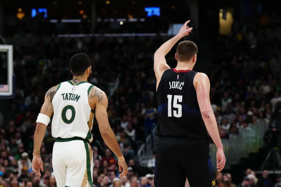 Boston Celtics forward Jayson Tatum (0) and Denver Nuggets center Nikola Jokic (15) during the first half at Ball Arena on Thursday night. The Nuggets won the game in would could be an NBA Finals preview.