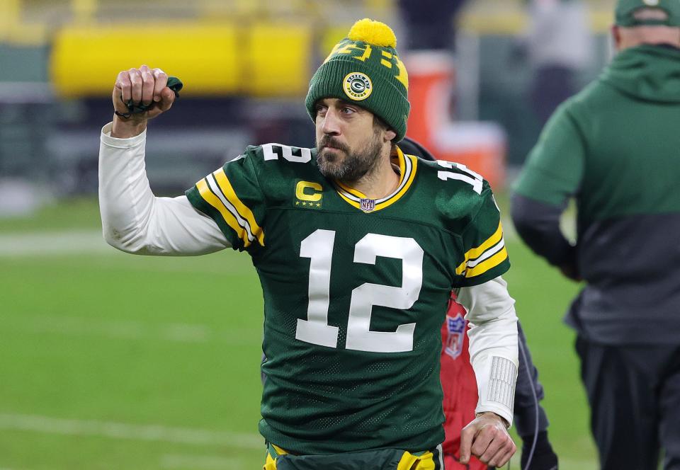 Aaron Rodgers of the Green Bay Packers celebrates defeating the Los Angeles Rams 32-18 in the NFC Divisional Playoff game at Lambeau Field on January 16, 2021 in Green Bay, Wisconsin.