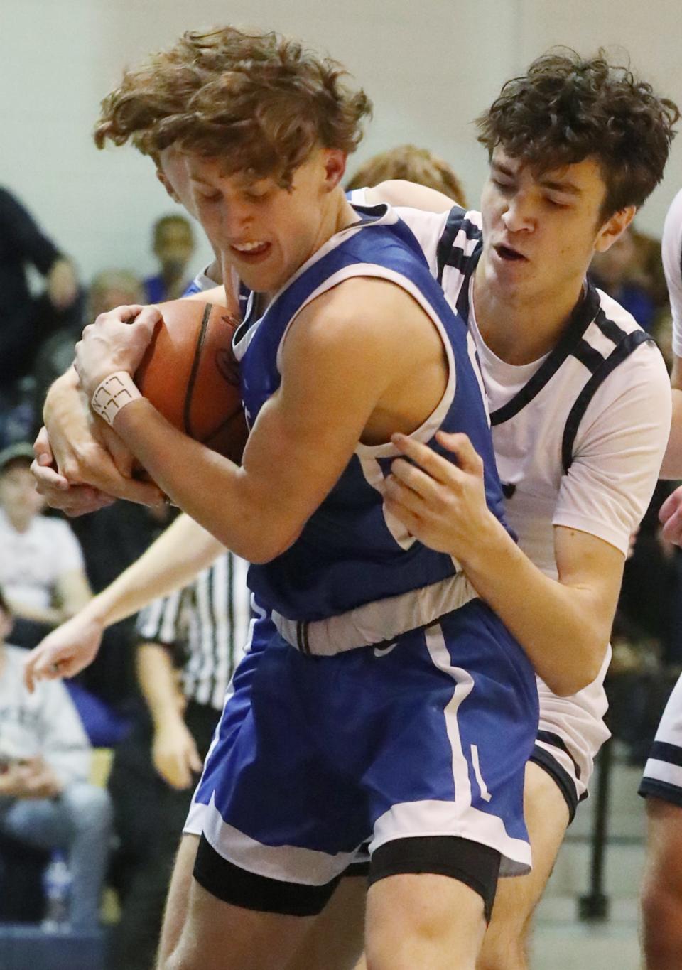 Lake's Chance Casenhiser battles Hoban's Andrew Griffith for a rebound during their game at Archbishop Hoban High School on Jan. 11 in Akron.