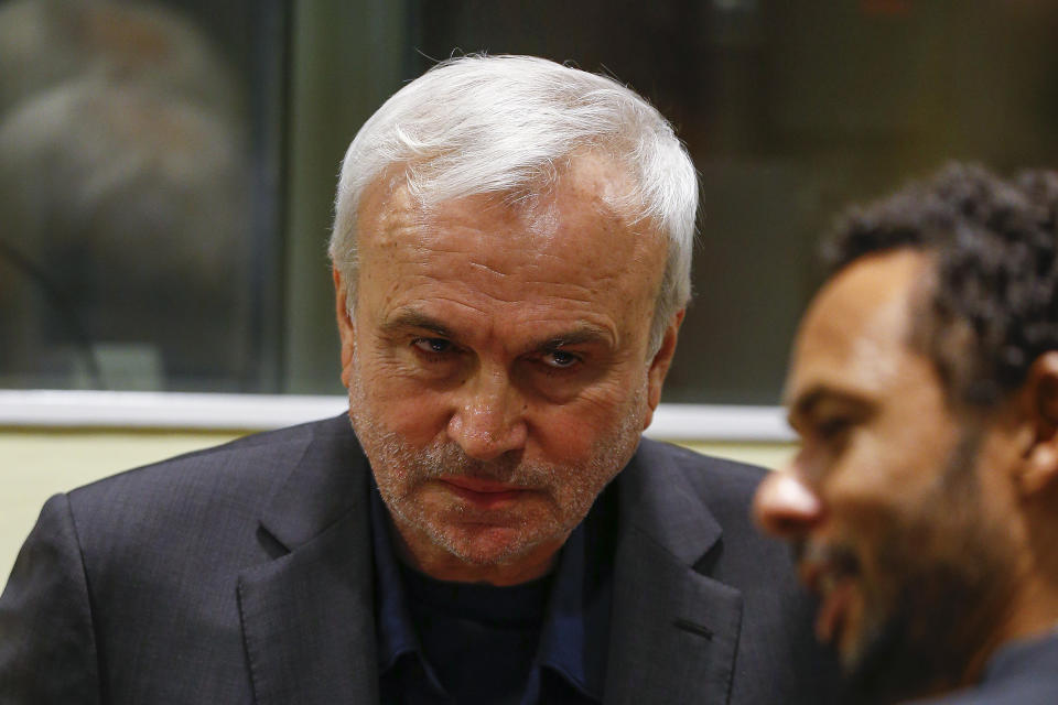 FILE - Jovica Stanisic, facing camera, appears in court for his retrial at the United Nations Mechanism for International Criminal Tribunals in The Hague, on June 13, 2017. The appeals decision on Wednesday, May 31, 2023 by the International Residual Mechanism for Criminal Tribunals in the retrial of Jovica Stanisic and Franko Simatovic brings to an end the longest-running war crimes prosecution dating back to the Balkan wars of the early 1990s. (Michael Kooren/Pool Photo via AP, File)