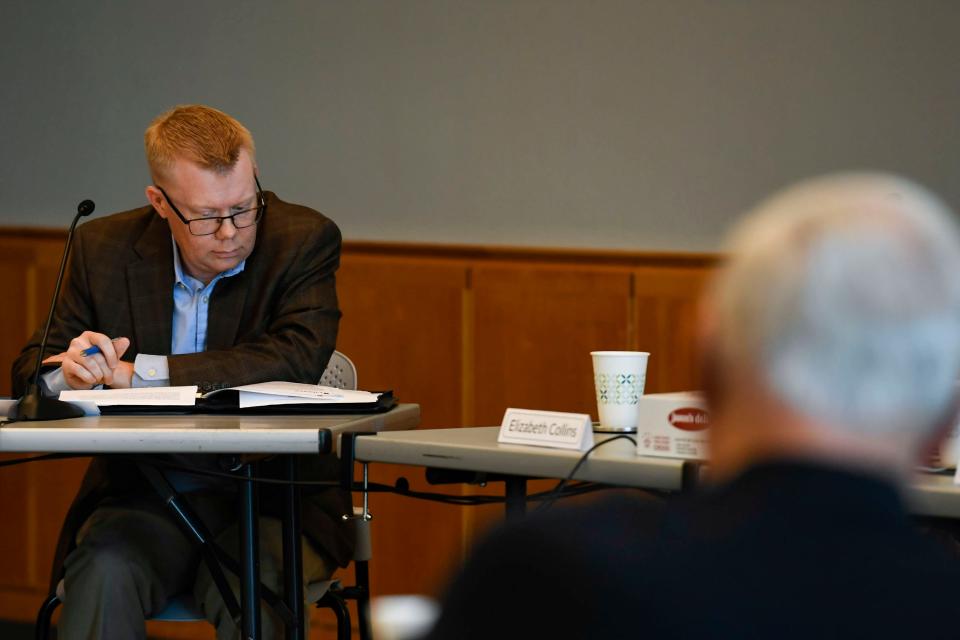 Brian Aufmuth, on the Greenville Public Library board of trustees, reads over a document as the board discusses the issue of library displays during a board meeting on Friday Oct. 13, 2023.