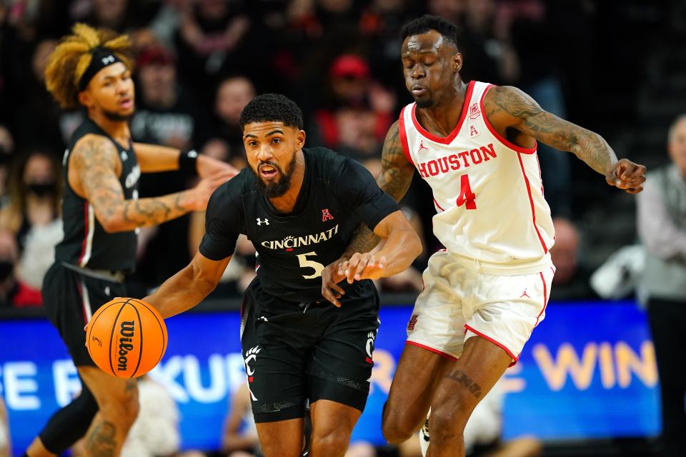 Cincinnati Bearcats guard David DeJulius (5) steals the ball from Houston Cougars guard Taze Moore (4) in the first half of an NCAA menÕs college basketball game, Sunday, Feb. 6, 2022, at Fifth Third Arena in Cincinnati.