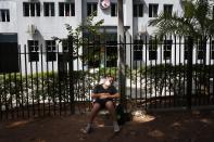 Marcelo Rolon sleeps outside the ICU of the Respiratory Hospital, INERAM, where his father Gerardo Rolon is treated for COVID-19 in Asuncion, Paraguay, Wednesday, March 3, 2021. Without vaccines or basic drugs to combat COVID-19, Paraguay’s main public hospitals became unable to receive patients in intensive care units on Wednesday. (AP Photo/Jorge Saenz)