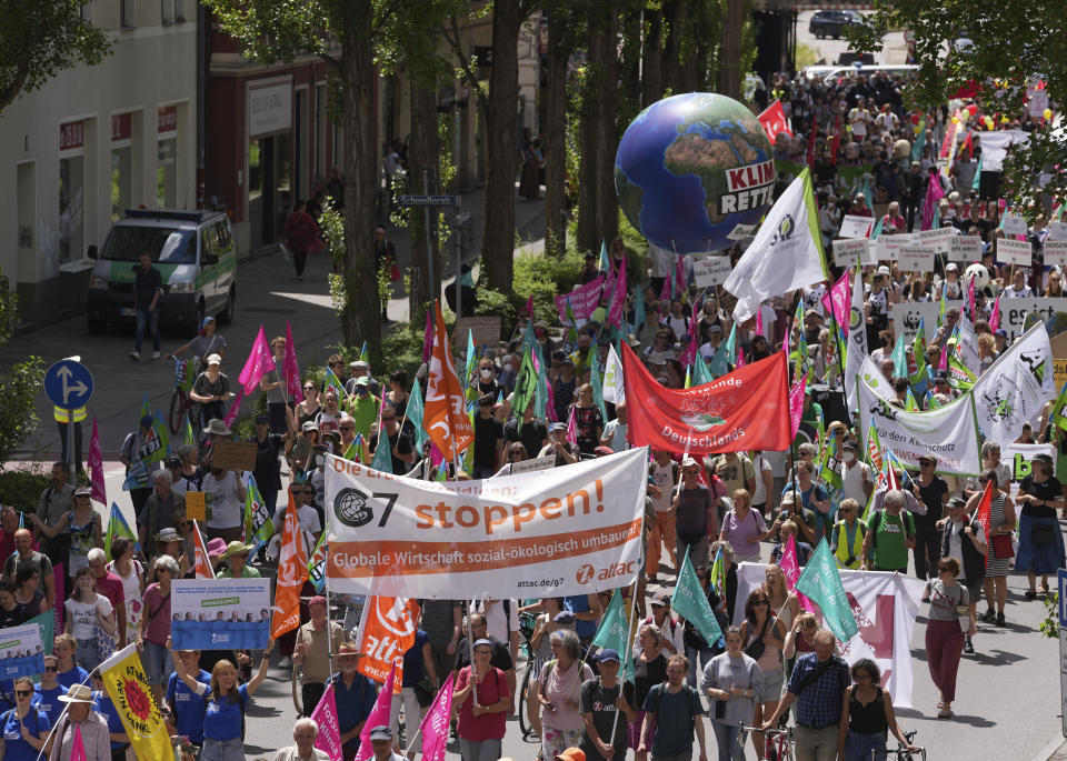 FILE - Climate activists and others hold banners and signs as they march during a demonstration ahead of a G-7 meeting in Munich, Germany, June 25, 2022. At this year's G-7 summit, Germany will push its plan for countries to join together in a ‘climate club' to tackle global warming. (AP Photo/Matthias Schrader, File)