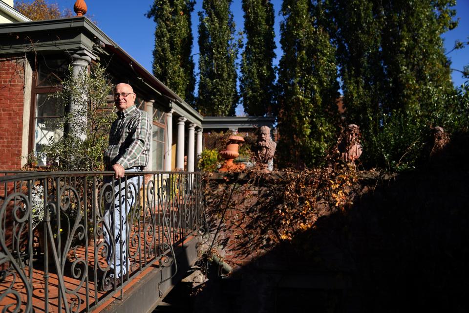 Cincinnati sculptor Ted Gantz built a two-level garden at his Prospect Hill home. He grows herbs in pots on the veranda.