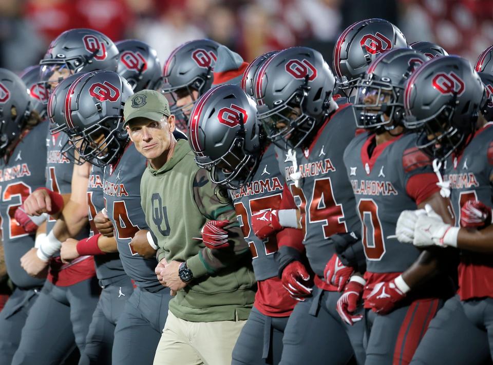 Oklahoma head coach Brent Venables lines up with players before the college football game between the University of Oklahoma Sooners and the West Virginia Mountaineers at Gaylord Family-Oklahoma Memorial Stadium in Norman, Okla., Saturday, Nov., 11, 2023.