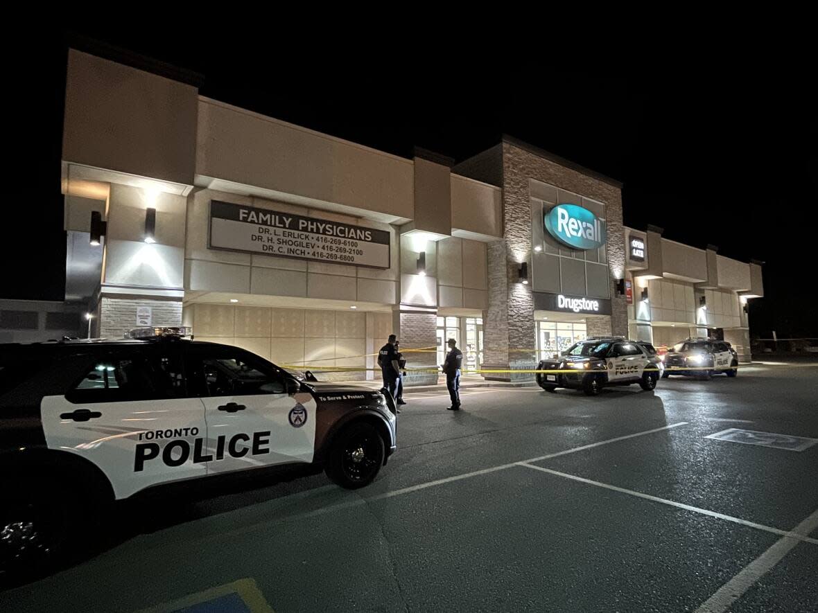 Toronto police say just after 8 p.m. they were called to the area of Eglinton Avenue East and Brimley Road after two males with firearms entered a store. A man in his 60s was shot and is in life-threatening condition. (Alexis Raymon/CBC - image credit)