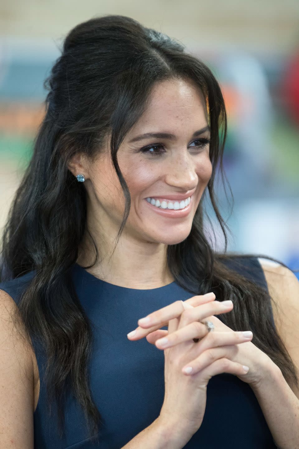 Meghan with a wavy half-up half-down 'do in 2018